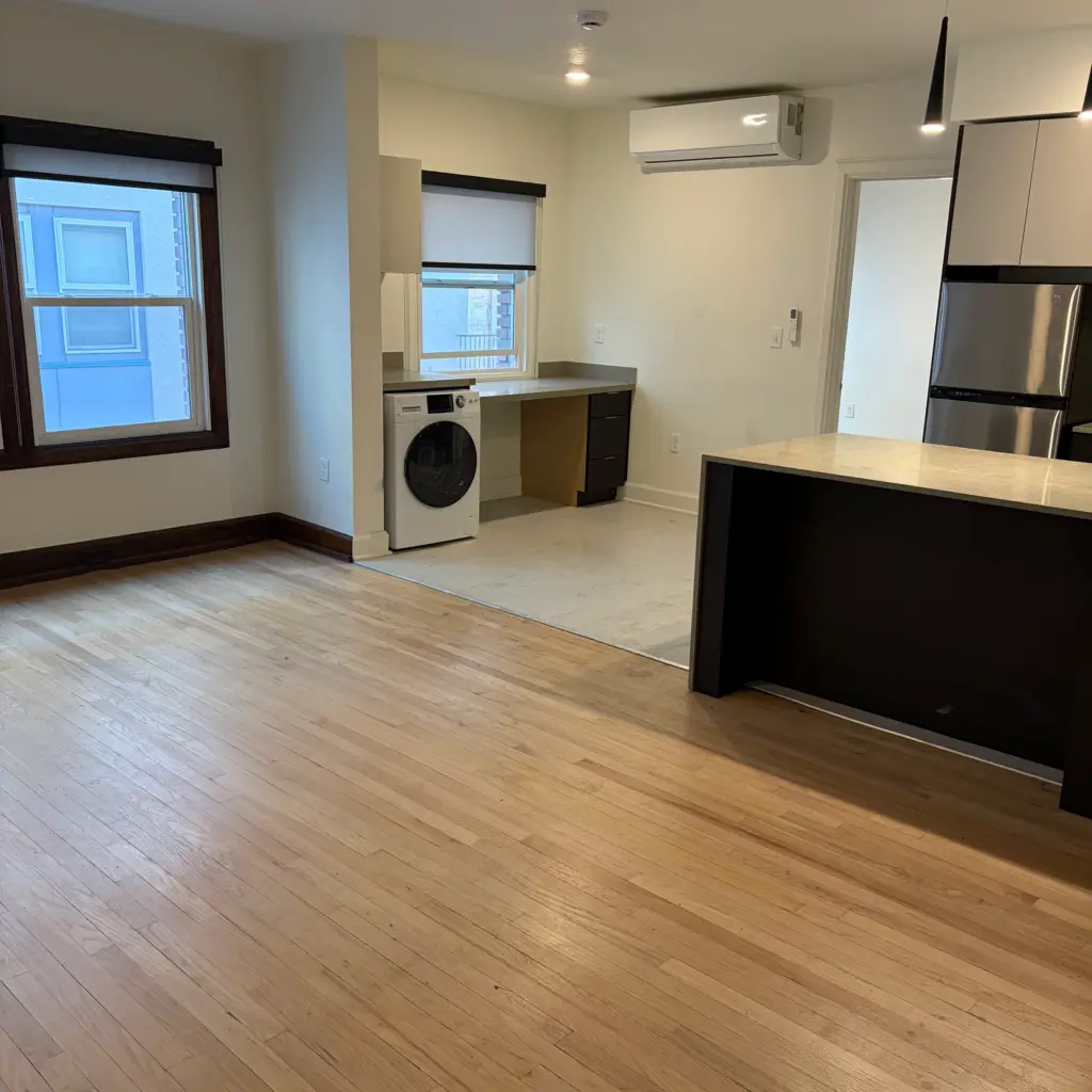 Empty apartment with clean wood floors after a full cleanout