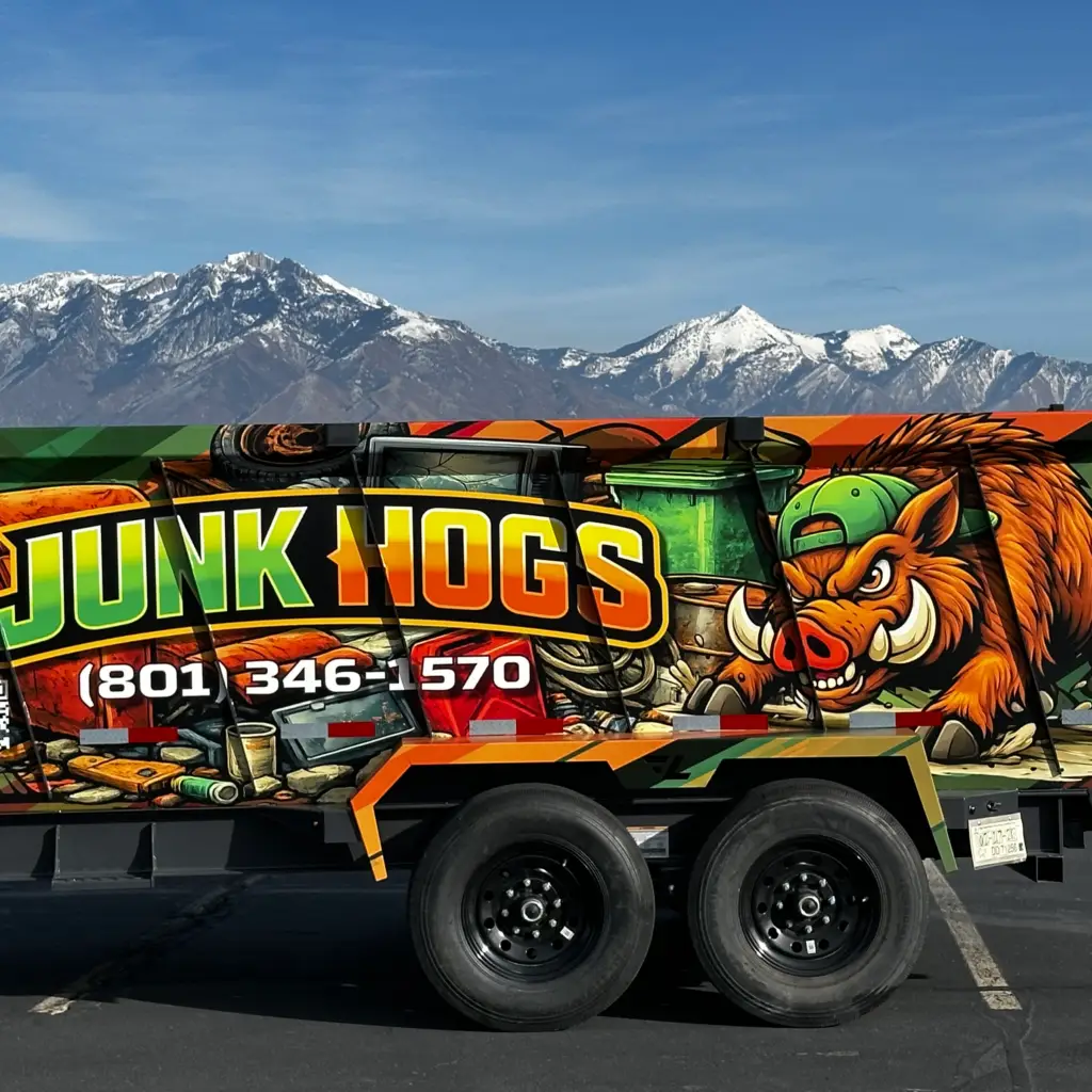 Junk Hogs wrapped junk removal trailer with the Wasatch Mountains behind it